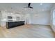 Open-concept kitchen and living room with hardwood floors and modern lighting fixtures at 213 Admor Ln, Acworth, GA 30102