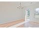 Bright room with hardwood floors, modern lighting, and a door leading to the backyard at 213 Admor Ln, Acworth, GA 30102