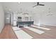 Open-concept living room and kitchen featuring hardwood floors, a kitchen island, and natural light at 213 Admor Ln, Acworth, GA 30102