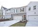 Street view of townhomes with attached garages and brick accents at 213 Admor Ln, Acworth, GA 30102