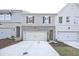 Charming townhomes featuring brick accents, gray siding, and inviting garage entrances at 213 Admor Ln, Acworth, GA 30102
