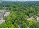 Aerial view of lush trees and the house, located near city buildings at 2565 Bates Se St, Smyrna, GA 30080