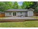 The backyard features a pea gravel patio, wooden deck, modern furniture, and well-kept grass at 2565 Bates Se St, Smyrna, GA 30080
