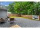 Relaxing backyard retreat featuring pea gravel, modern seating, and a charming fire pit at 2565 Bates Se St, Smyrna, GA 30080
