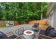 Charming backyard space with a fire pit, modern furniture, and a wood fence at 2565 Bates Se St, Smyrna, GA 30080