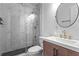 Bathroom featuring modern fixtures, bright vanity, and tiled shower with glass door at 2565 Bates Se St, Smyrna, GA 30080