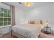 Cozy bedroom featuring a queen-sized bed, natural lighting, and a stylish woven light fixture at 2565 Bates Se St, Smyrna, GA 30080