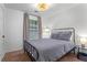Comfortable bedroom with a full-sized bed, side table with lamp, and a view to the backyard at 2565 Bates Se St, Smyrna, GA 30080