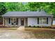 Charming home with gray siding, black shutters, and a cozy front porch at 2565 Bates Se St, Smyrna, GA 30080