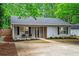 Charming single-story home with gray siding, black shutters, and a well-manicured front yard at 2565 Bates Se St, Smyrna, GA 30080