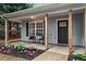 Inviting front porch with stylish seating and lush landscaping, perfect for relaxing outdoors at 2565 Bates Se St, Smyrna, GA 30080