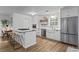 Bright eat-in kitchen boasts white cabinets, stainless appliances, granite counters and a farmhouse sink at 2565 Bates Se St, Smyrna, GA 30080