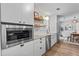 Modern eat-in kitchen with stainless appliances, granite counters, floating shelves and dining area at 2565 Bates Se St, Smyrna, GA 30080