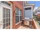 Back deck features wooden flooring, grill, brick siding and a glass back door with blinds at 2690 Derby Ne Walk # 53, Atlanta, GA 30319