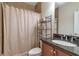 Bathroom features wood cabinets, granite countertops, tan walls and shower with curtain at 2690 Derby Ne Walk # 53, Atlanta, GA 30319