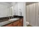 Bathroom features granite countertops, wood cabinets, undermount sink and shower with white and gray curtain at 2690 Derby Ne Walk # 53, Atlanta, GA 30319