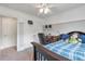 Bedroom features plush carpet, ceiling fan, half painted walls, desk, bed and ceiling fan at 2690 Derby Ne Walk # 53, Atlanta, GA 30319