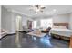 Bedroom features hard flooring, ceiling fan, window, neutral walls, bed and furniture at 2690 Derby Ne Walk # 53, Atlanta, GA 30319
