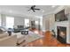 Open-concept living room with fireplace and hardwood floors at 2690 Derby Ne Walk # 53, Atlanta, GA 30319