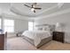 Spacious main bedroom with tray ceilings, plush carpeting, and a cozy sitting area at 2690 Derby Ne Walk # 53, Atlanta, GA 30319