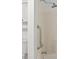 Clean, bright bathroom with a tub and shower combo and safety handrail at 2746 Sanibel Se Ln, Smyrna, GA 30082
