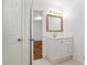 Bathroom vanity with tiled flooring, gold framed mirror, and a door that leads to the bedroom at 2746 Sanibel Se Ln, Smyrna, GA 30082