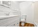 Bathroom with a white vanity, toilet, mirror, and a shower with clear glass doors at 2746 Sanibel Se Ln, Smyrna, GA 30082