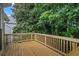 New wooden deck with a natural wood finish, overlooking the backyard at 2746 Sanibel Se Ln, Smyrna, GA 30082