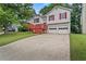 Two-story home with white siding, red shutters, wooden deck, and two-car garage at 2746 Sanibel Se Ln, Smyrna, GA 30082
