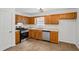 Practical kitchen featuring wood cabinets, modern appliances, and functional tile flooring at 2746 Sanibel Se Ln, Smyrna, GA 30082