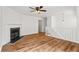 Spacious living room with hardwood floors, a fireplace, and an open layout with access to the staircase at 2746 Sanibel Se Ln, Smyrna, GA 30082