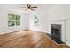 Sunlit living room featuring new floors, a cozy fireplace, and large windows offering neighborhood views at 2746 Sanibel Se Ln, Smyrna, GA 30082