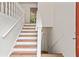 Bright staircase with white railings and wood steps, leading to the upper level of the home at 2746 Sanibel Se Ln, Smyrna, GA 30082
