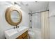 Modern bathroom with a stylish sink, round mirror, and a shower-tub combination at 3235 Roswell Ne Rd # 521, Atlanta, GA 30305