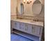 Bathroom with a double sink vanity, stone countertops, and custom mirrors at 3235 Roswell Ne Rd # 521, Atlanta, GA 30305