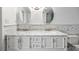 Elegant bathroom features a double sink vanity with marble countertop, stylish mirrors, and modern fixtures at 3235 Roswell Ne Rd # 521, Atlanta, GA 30305