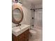 Modern bathroom with sleek fixtures, subway tile shower, wood vanity, and eye-catching lighting at 3235 Roswell Ne Rd # 521, Atlanta, GA 30305