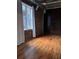 Bedroom with hardwood floors and exposed brick wall. Window lets in plenty of natural light at 3235 Roswell Ne Rd # 521, Atlanta, GA 30305