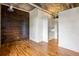 Bedroom with wood-paneled accent wall, hardwood floors, and stylish built-in storage and lighting at 3235 Roswell Ne Rd # 521, Atlanta, GA 30305