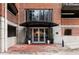 Building entrance featuring a canopy, glass doors, and brick facade at 3235 Roswell Ne Rd # 521, Atlanta, GA 30305
