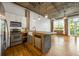 Modern kitchen features stainless steel appliances, white cabinets, and hardwood flooring at 3235 Roswell Ne Rd # 521, Atlanta, GA 30305