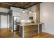 Modern kitchen featuring stainless steel appliances, wood accents, and pendant lighting at 3235 Roswell Ne Rd # 521, Atlanta, GA 30305