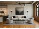 Bright living room with modern furnishings, an open ceiling, and ductwork, and hardwood floors at 3235 Roswell Ne Rd # 521, Atlanta, GA 30305