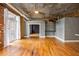 Open-concept living room with exposed ceilings and a doorway leading to another room at 3235 Roswell Ne Rd # 521, Atlanta, GA 30305