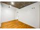 Open living room area with industrial ceiling, hardwood floors and natural light at 3235 Roswell Ne Rd # 521, Atlanta, GA 30305