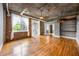 Spacious living room features hardwood floors, exposed brick, and large windows, creating a bright and inviting atmosphere at 3235 Roswell Ne Rd # 521, Atlanta, GA 30305