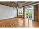 Spacious living room featuring exposed brick, hardwood floors, and abundant natural light at 3235 Roswell Ne Rd # 521, Atlanta, GA 30305