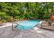 Outdoor pool surrounded by lounge chairs and lush greenery at 3235 Roswell Ne Rd # 521, Atlanta, GA 30305