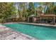 Community swimming pool with cabana, lounge seating, and nearby green space at 3235 Roswell Ne Rd # 521, Atlanta, GA 30305