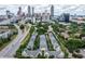 Stunning aerial view of townhomes in a lush, green setting with a city skyline backdrop and highway access at 375 Highland Ne Ave # 913, Atlanta, GA 30312